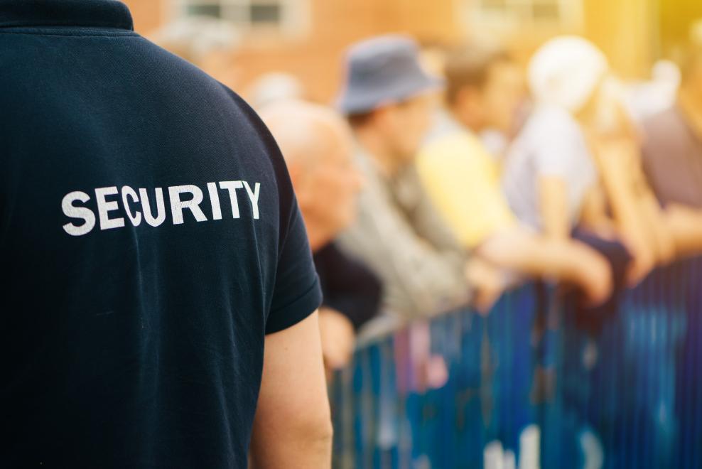 Event security guard standing at a barrier